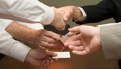 A group of people with a business card exchange.